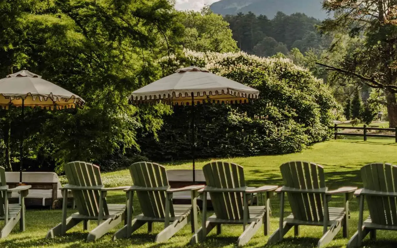 Rows of Adirondack chairs facing the mountains