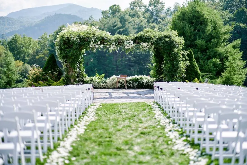 The ceremony arch and white chairs