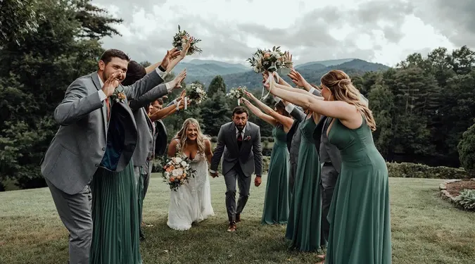 The wedding party cheering the couple